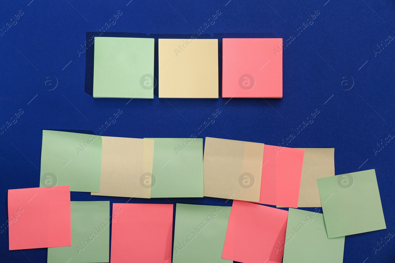 Photo of Many colorful stickers on blue background, flat lay