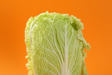 Photo of Fresh ripe Chinese cabbage on orange background, closeup