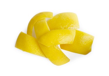 Pieces of fresh lemon peel on white background, top view. Citrus zest