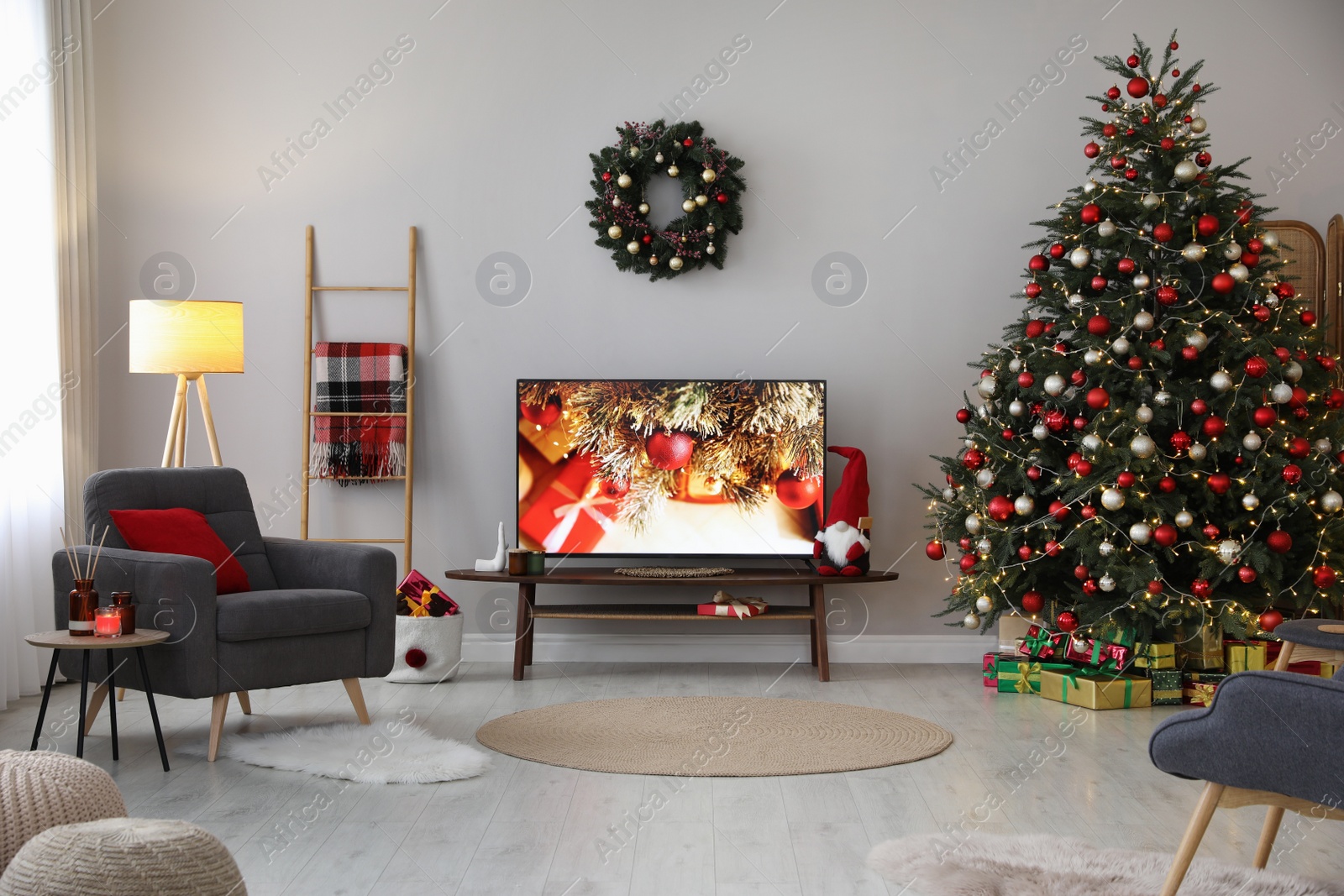 Photo of Stylish living room interior with modern TV and Christmas tree