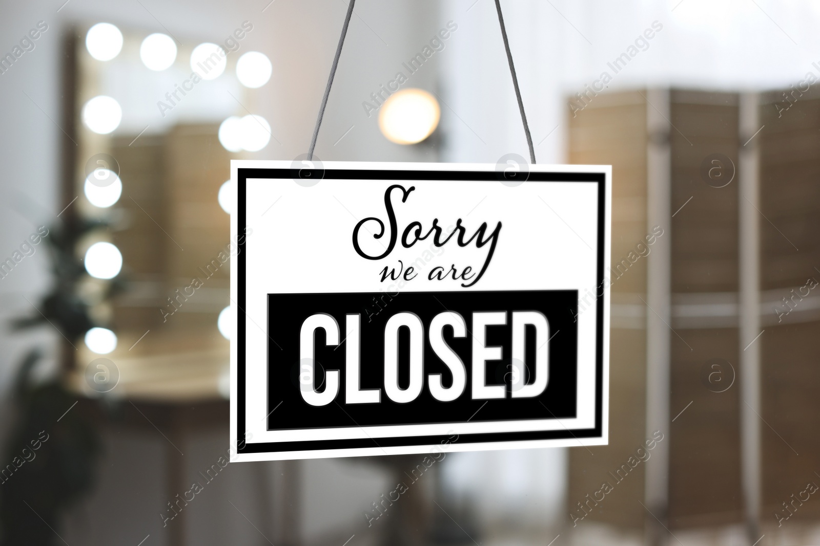 Image of Sorry we are closed sign against blurred background