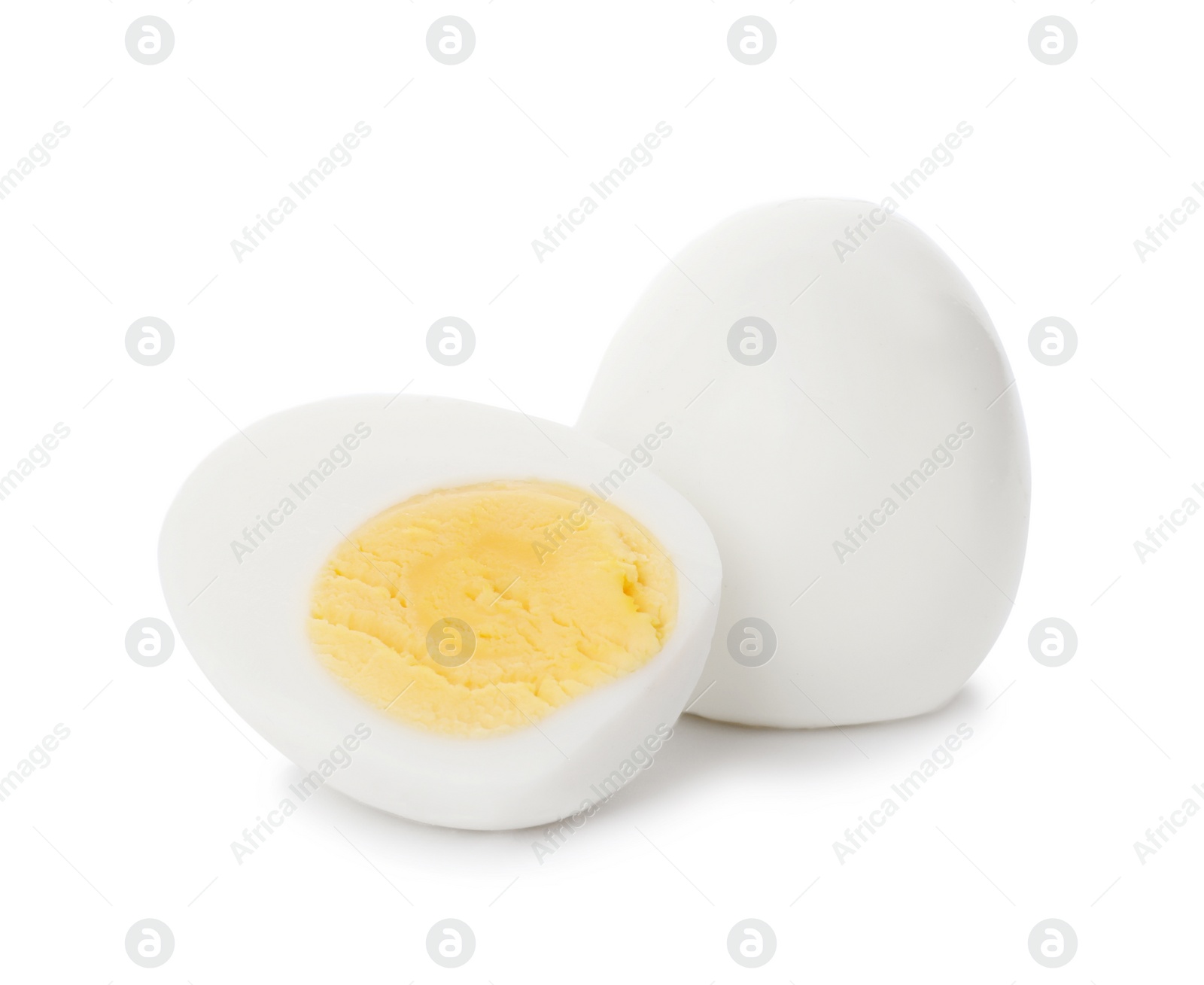 Photo of Sliced and whole hard boiled eggs on white background