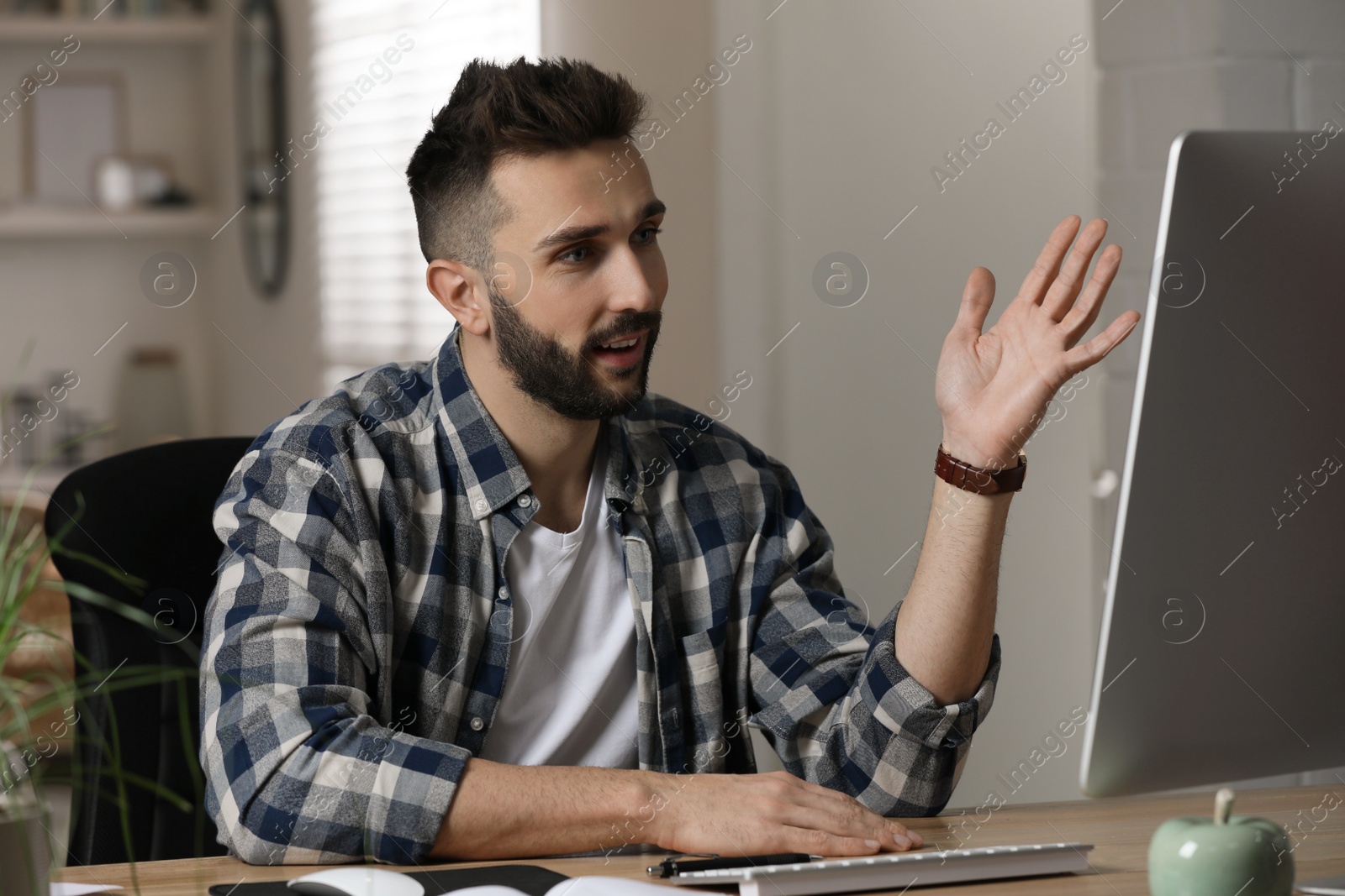 Photo of Man having video call on computer indoors. Working from home