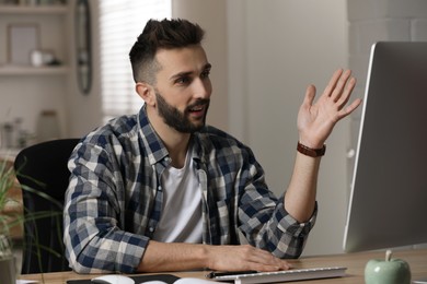 Man having video call on computer indoors. Working from home