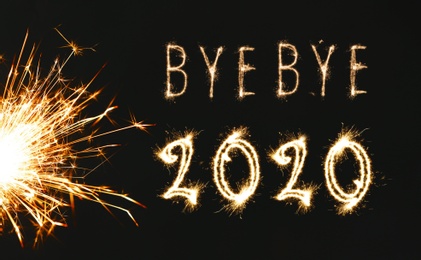 Image of  Bye Bye 2020. Bright text and sparkler on black background