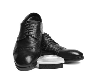 Stylish men's shoes and polishing sponge on white background