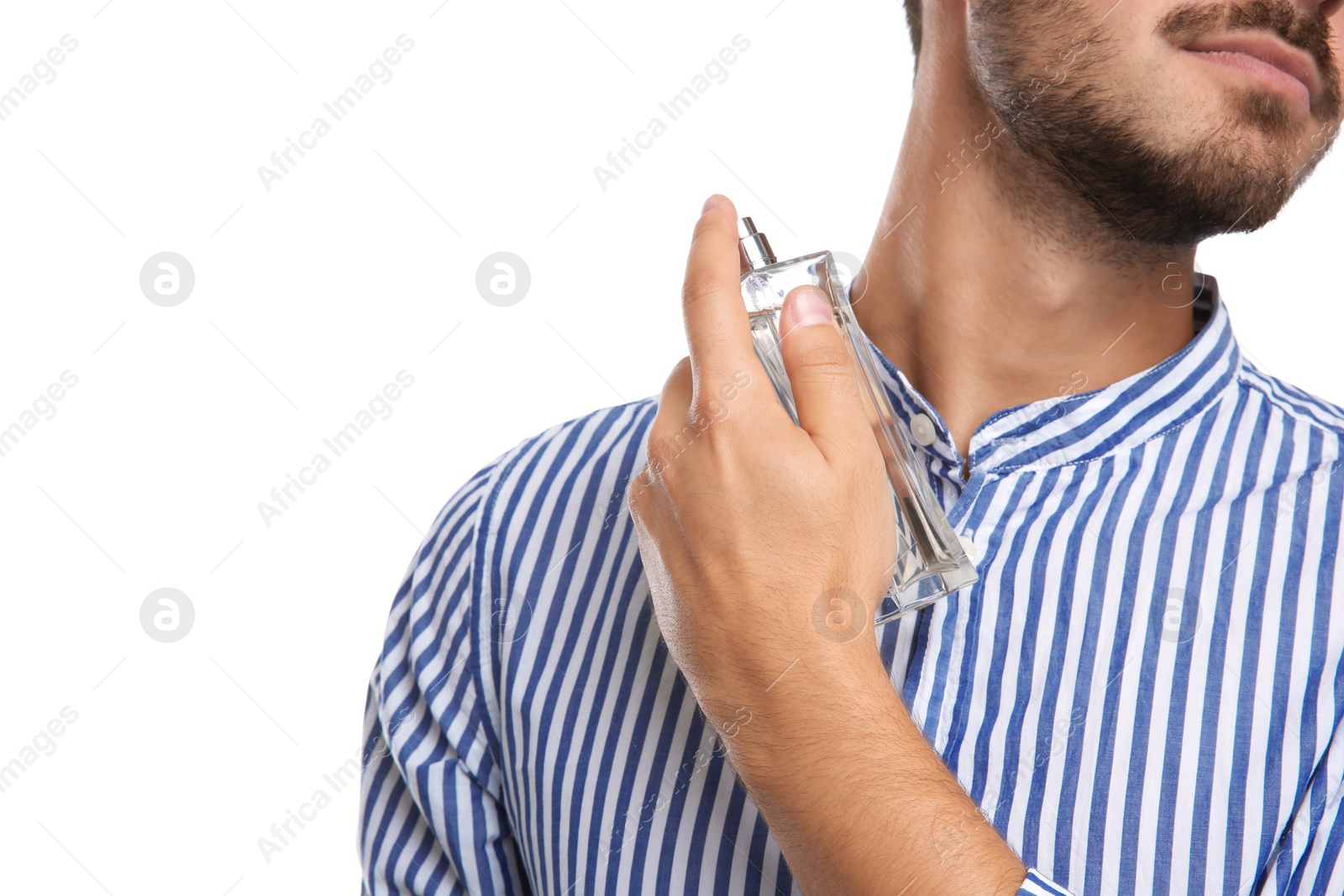 Photo of Young man applying perfume on white background, closeup