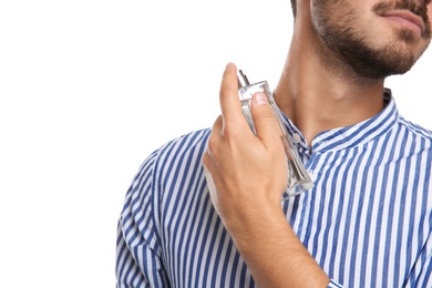 Photo of Young man applying perfume on white background, closeup