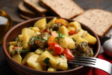 Photo of Tasty cooked dish with potatoes in earthenware, closeup