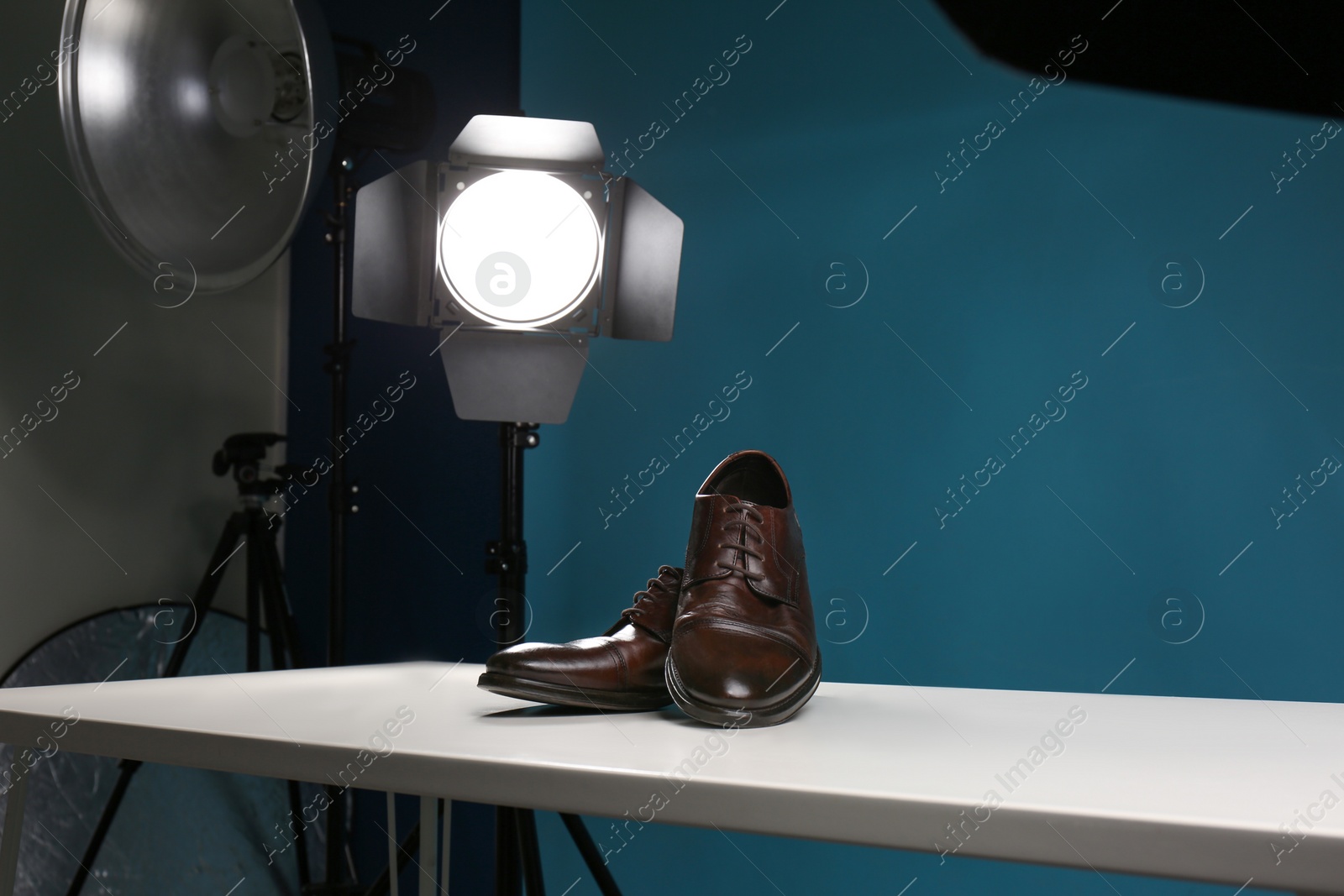 Photo of Shooting of men's shoes for product promotion in photo studio