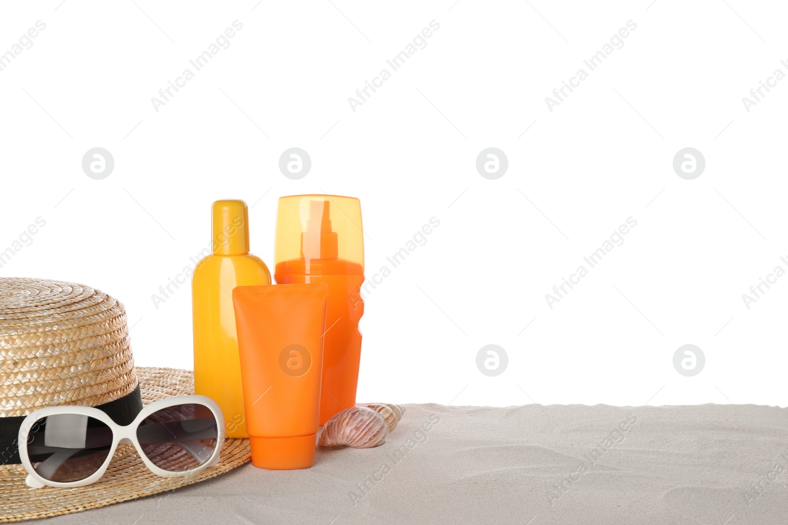 Photo of Composition with sun protection products on sand against white background. Space for text