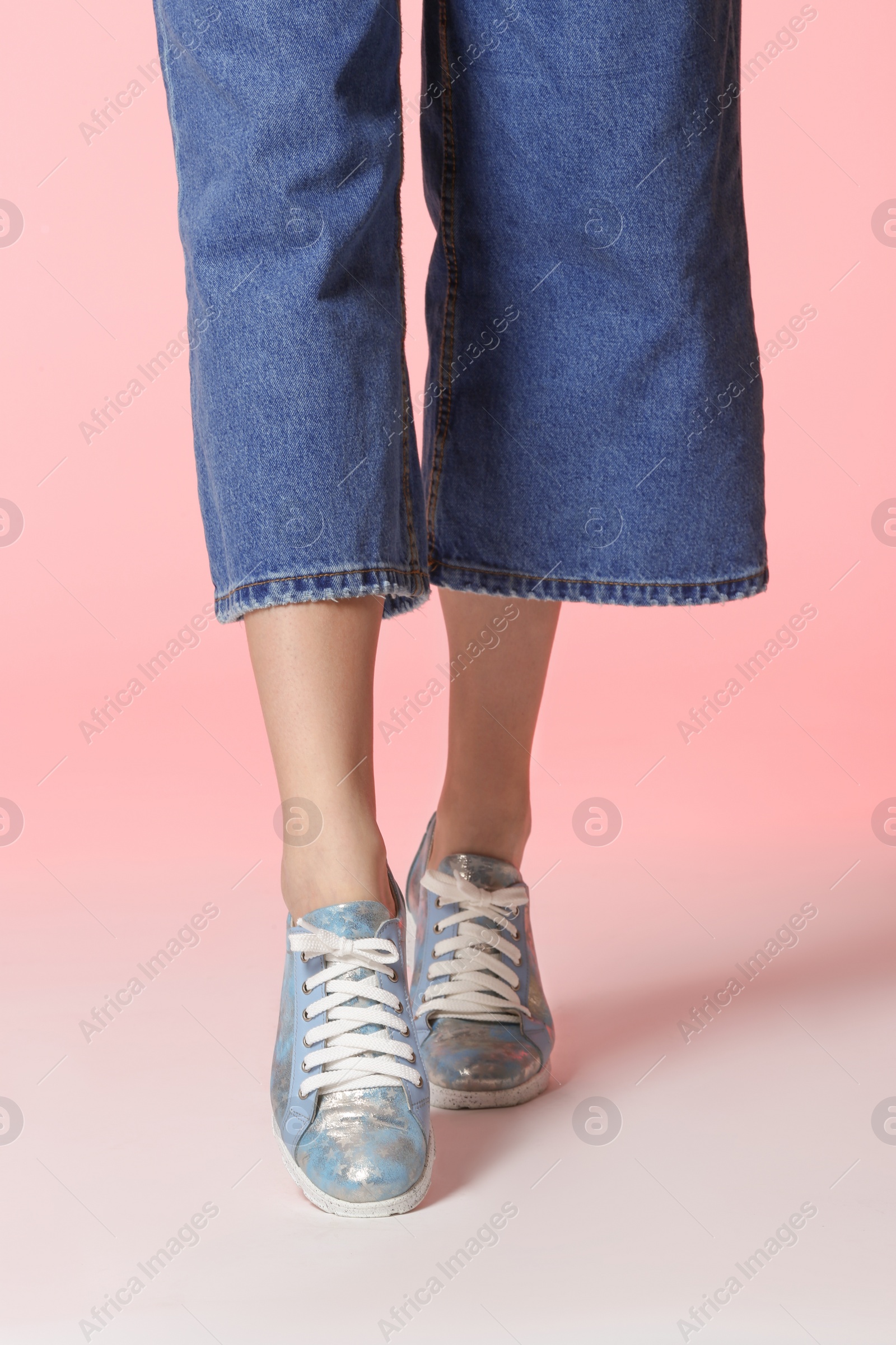 Photo of Woman in stylish shoes on color background, closeup