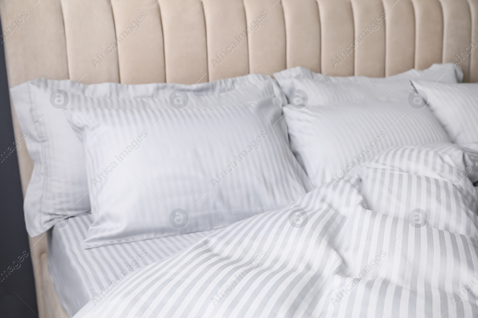 Photo of Comfortable bed with soft blanket and pillows, closeup