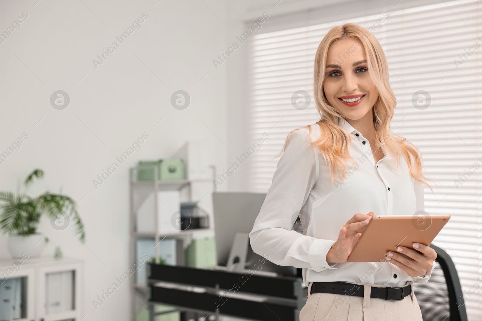 Photo of Happy secretary with tablet in office, space for text