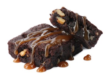 Delicious chocolate brownies with nuts and caramel sauce on white background