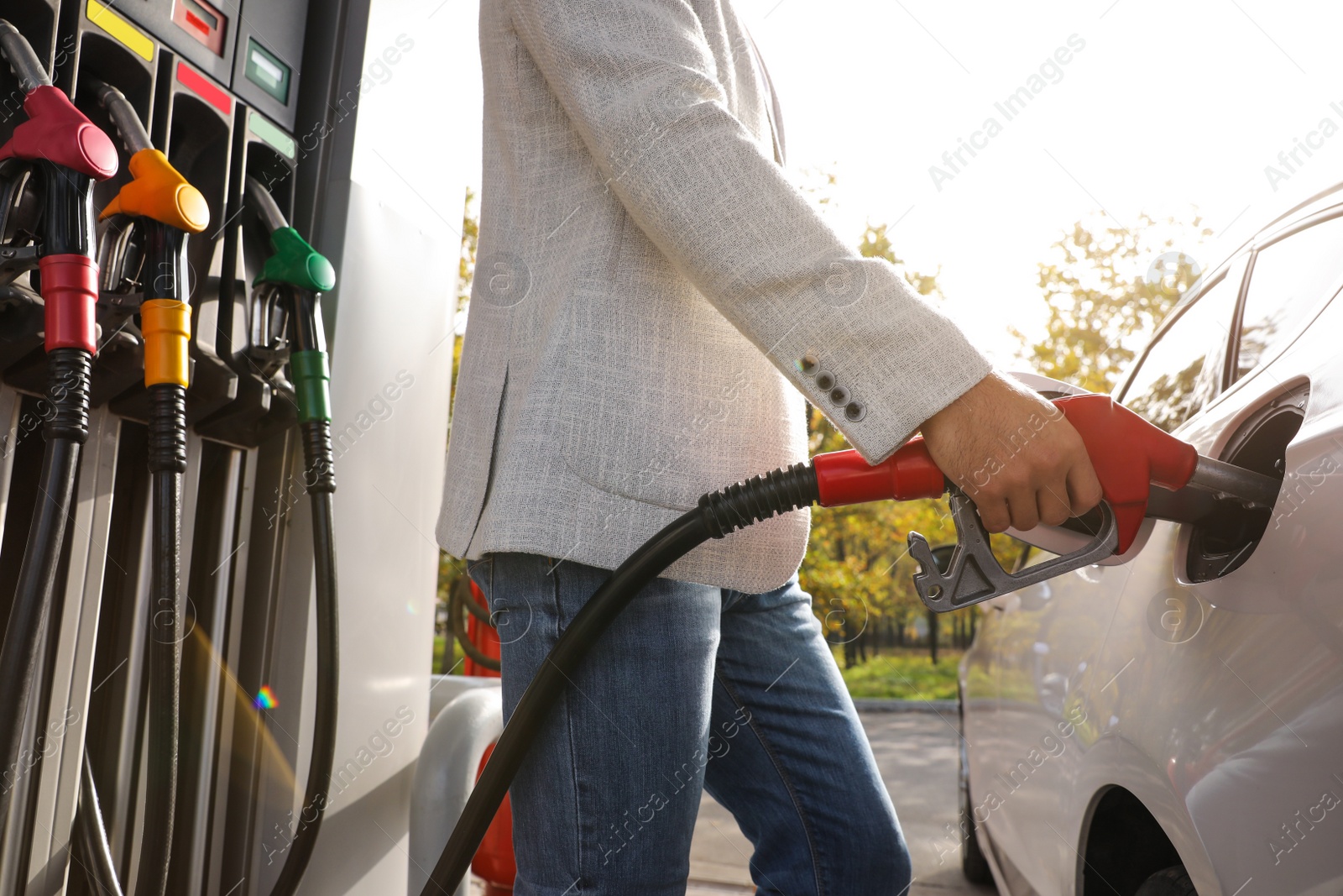 Photo of Man refueling car at self service gas station, closeup