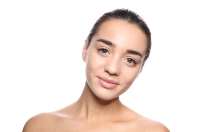 Portrait of young woman with liquid foundation on her face against white background