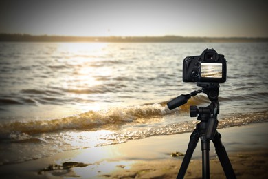Image of Taking photo of beautiful seascape with camera mounted on tripod