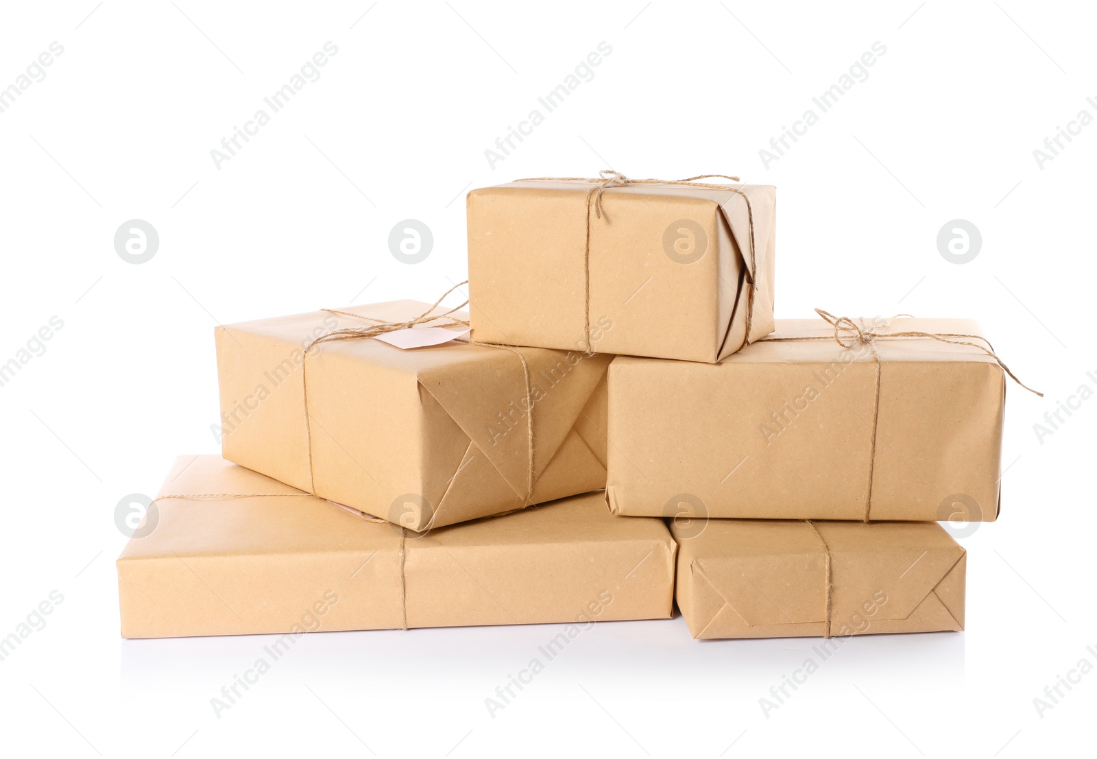 Photo of Parcels wrapped in kraft paper on white background