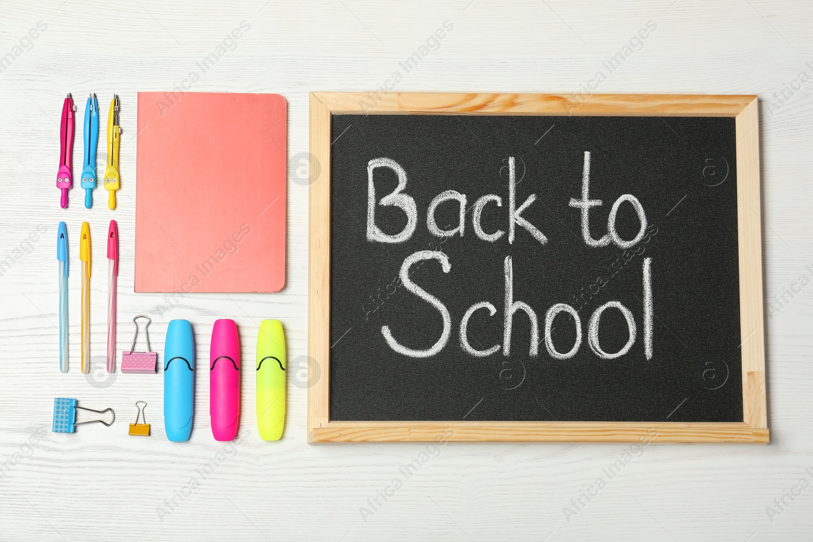 Photo of Flat lay composition with different school stationery and small chalkboard on wooden background