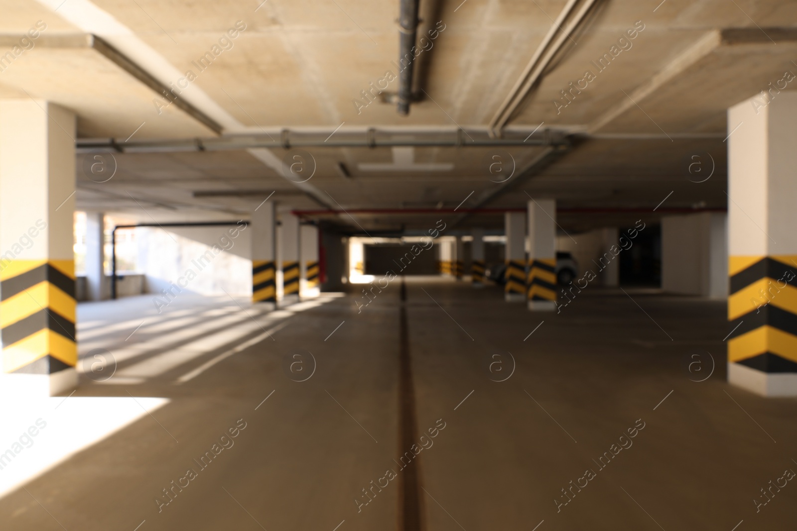 Photo of Blurred view of modern car parking garage