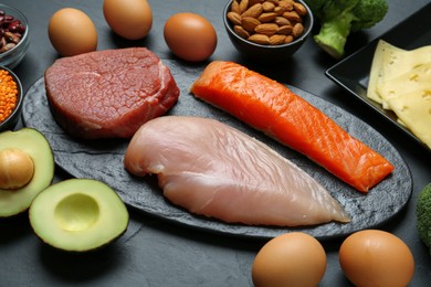 Fresh meat and other products on black table. Sources of essential amino acids