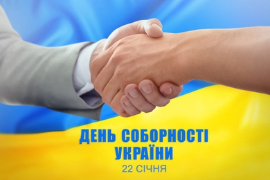 Unity Day of Ukraine. People shaking hands, text written in Ukrainian and national flag on background