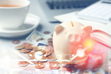 Image of Piggy bank and money on light table