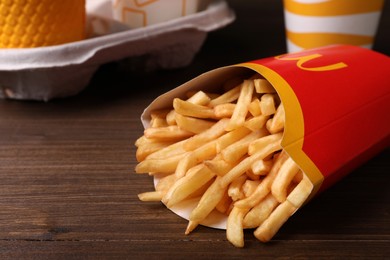 Photo of MYKOLAIV, UKRAINE - AUGUST 12, 2021: Big portion of McDonald's French fries on wooden table, closeup