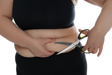 Obese woman with scissors on white background, closeup. Weight loss surgery