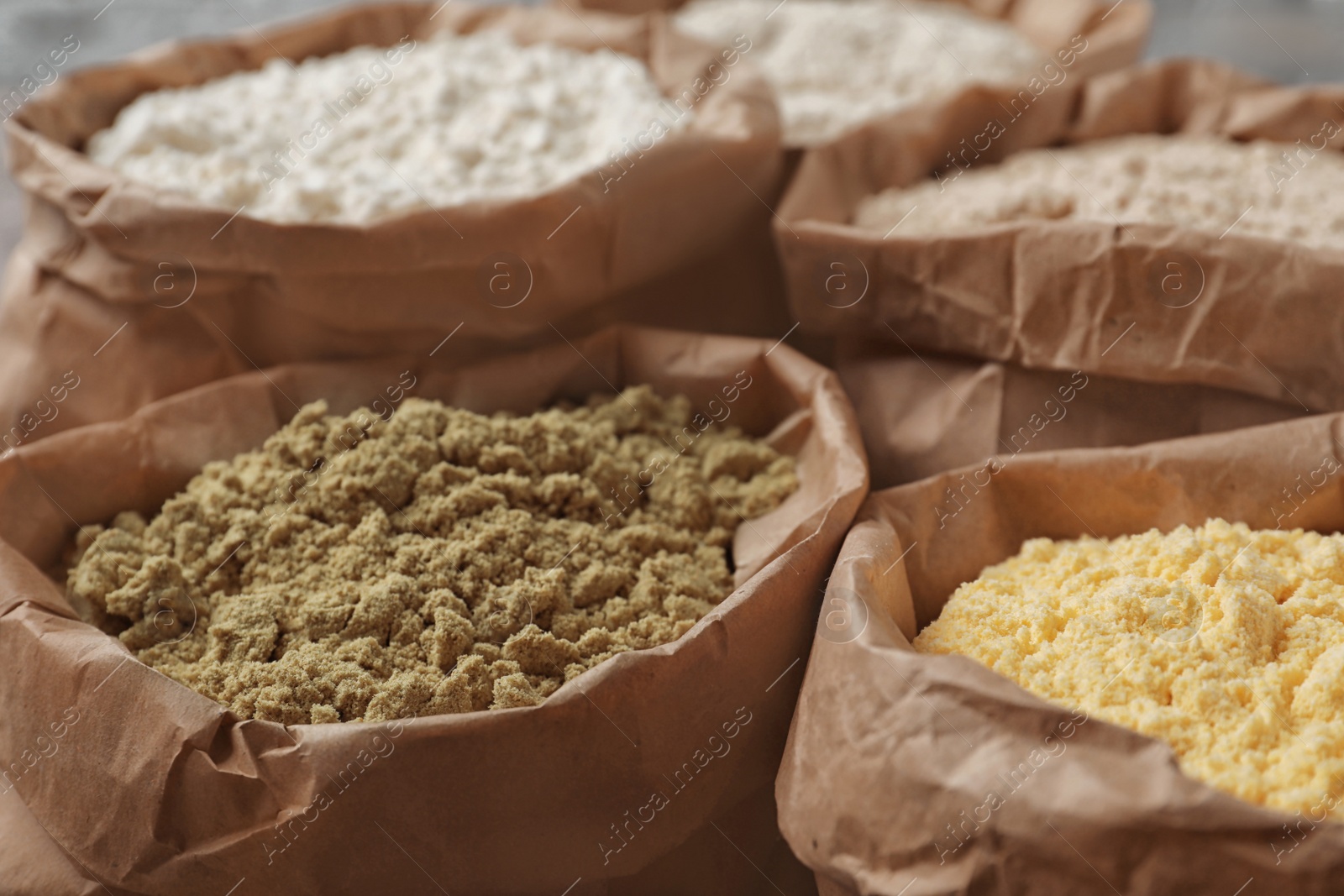 Photo of Paper bags with different types of flour, closeup