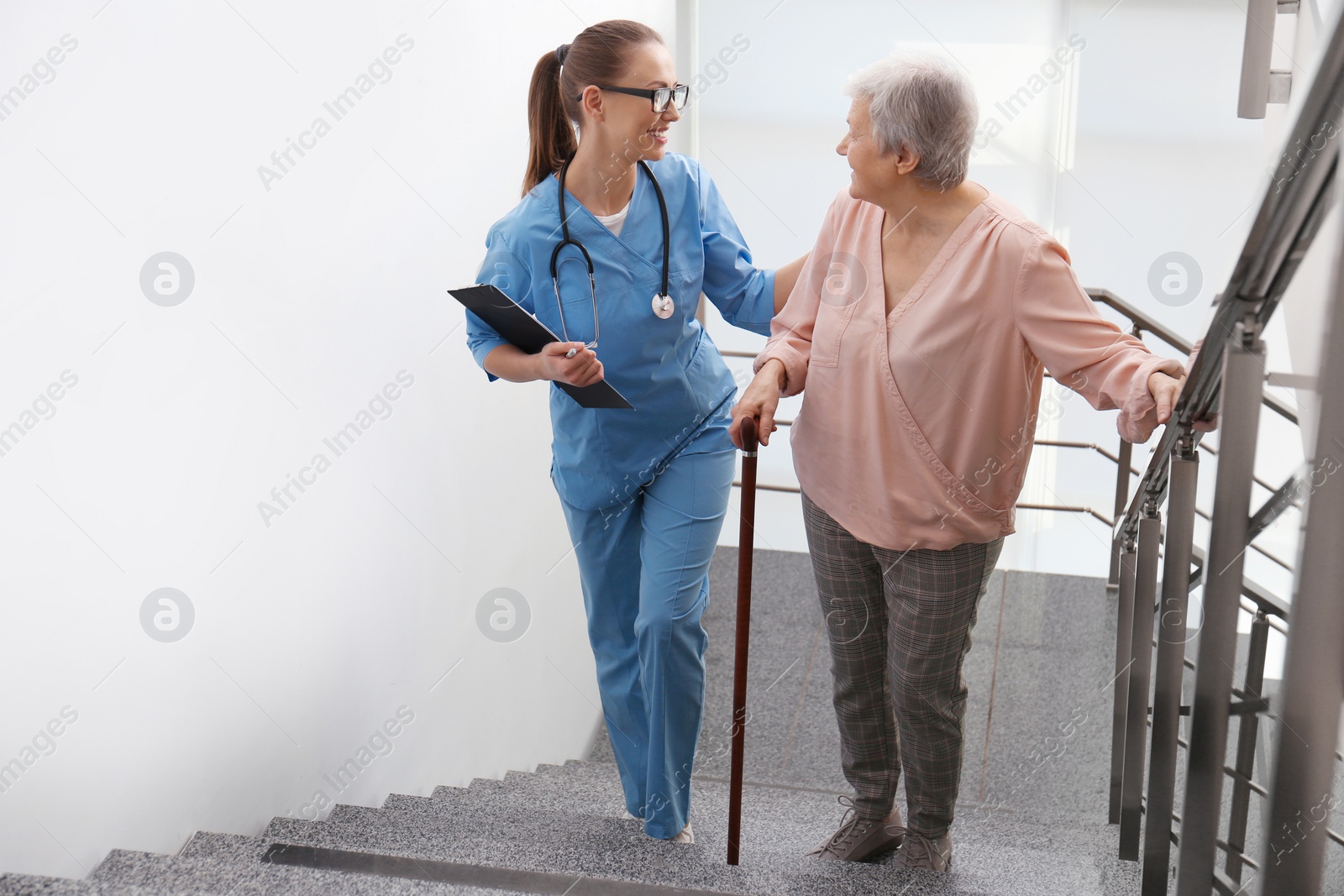 Photo of Doctor helping senior patient in modern hospital