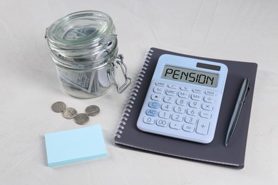 Image of Calculator with word Pension, money and stationery on light grey table