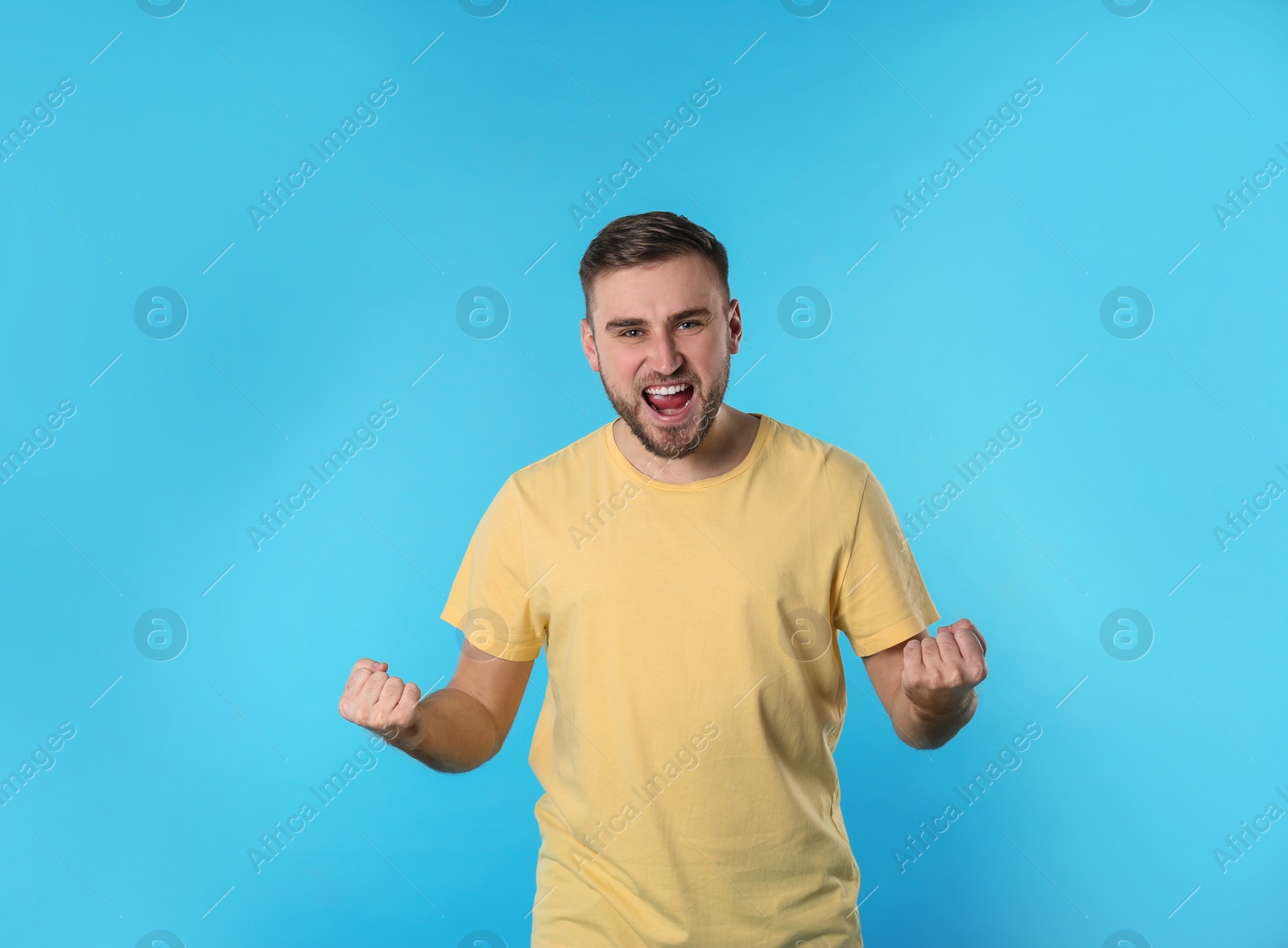 Photo of Portrait of emotional young man on color background