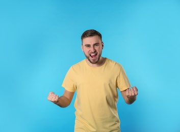 Photo of Portrait of emotional young man on color background