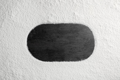 Oval frame made of flour on gray background, top view. Space for text