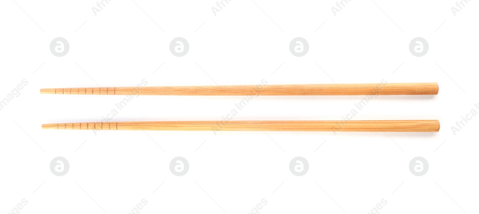 Photo of Chopsticks made of bamboo on white background, top view