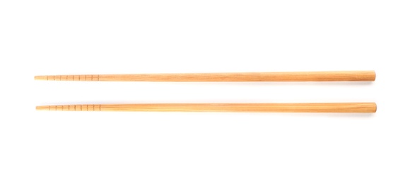 Chopsticks made of bamboo on white background, top view