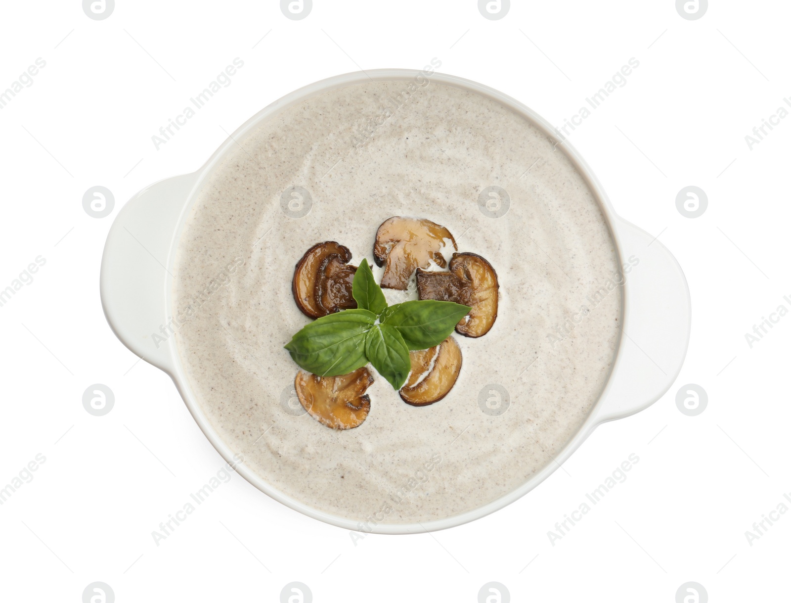 Photo of Fresh homemade mushroom soup in ceramic pot isolated on white, top view
