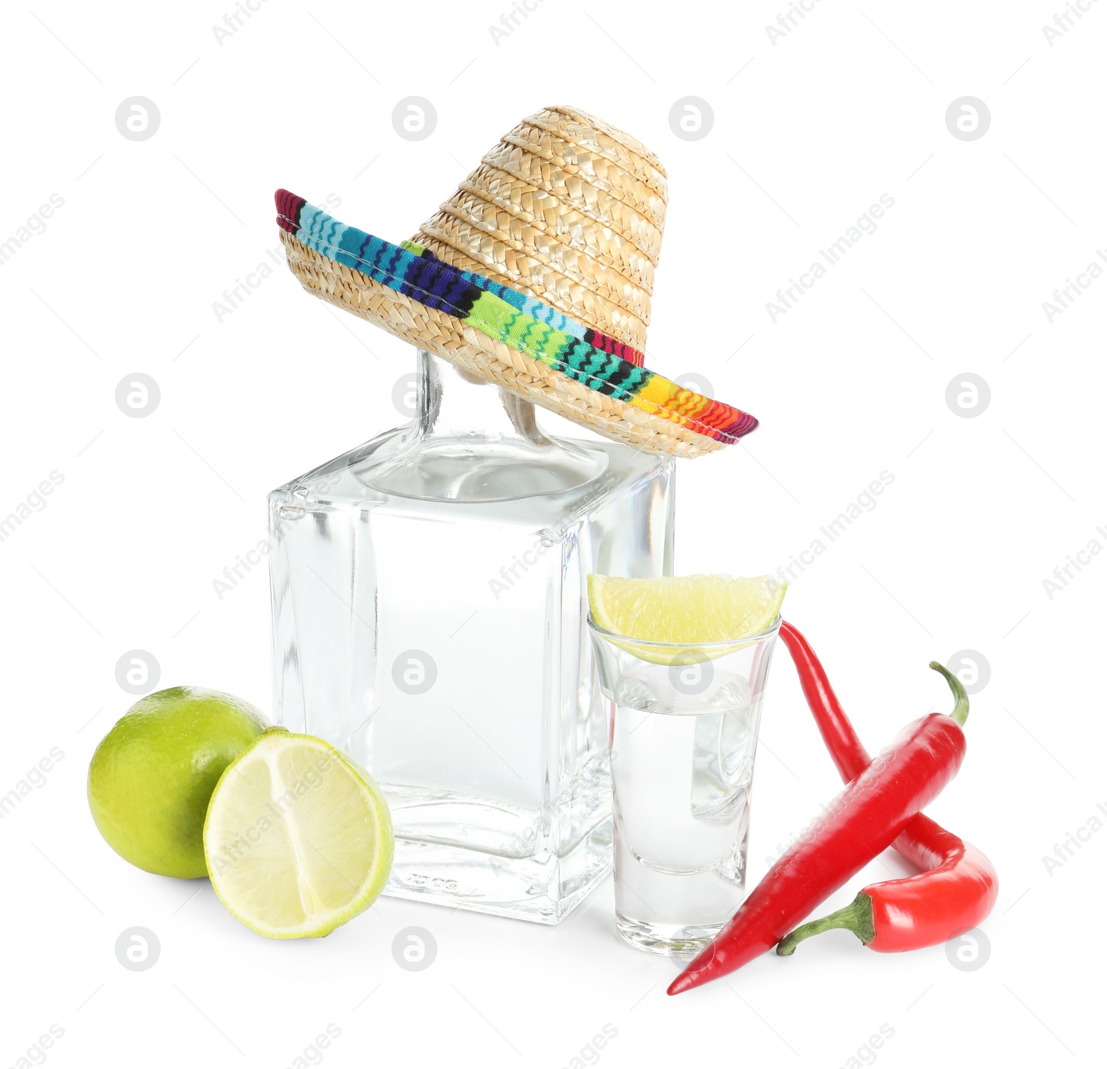 Photo of Mexican sombrero hat, tequila, chili peppers and limes isolated on white