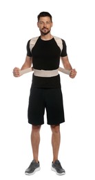 Photo of Handsome man with orthopedic corset on white background