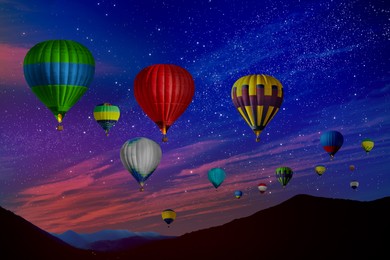 Image of Bright hot air balloons flying in starry sky over mountain