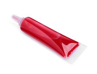 Photo of Tube with red food coloring on white background