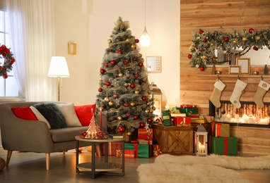 Image of Beautiful Christmas tree in living room. Festive interior