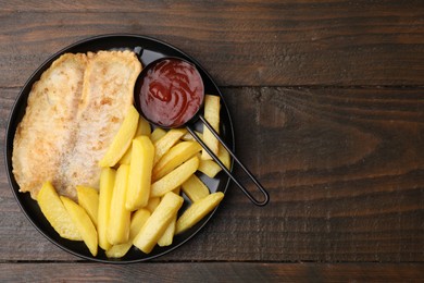 Delicious fish and chips with ketchup on wooden table, top view. Space for text