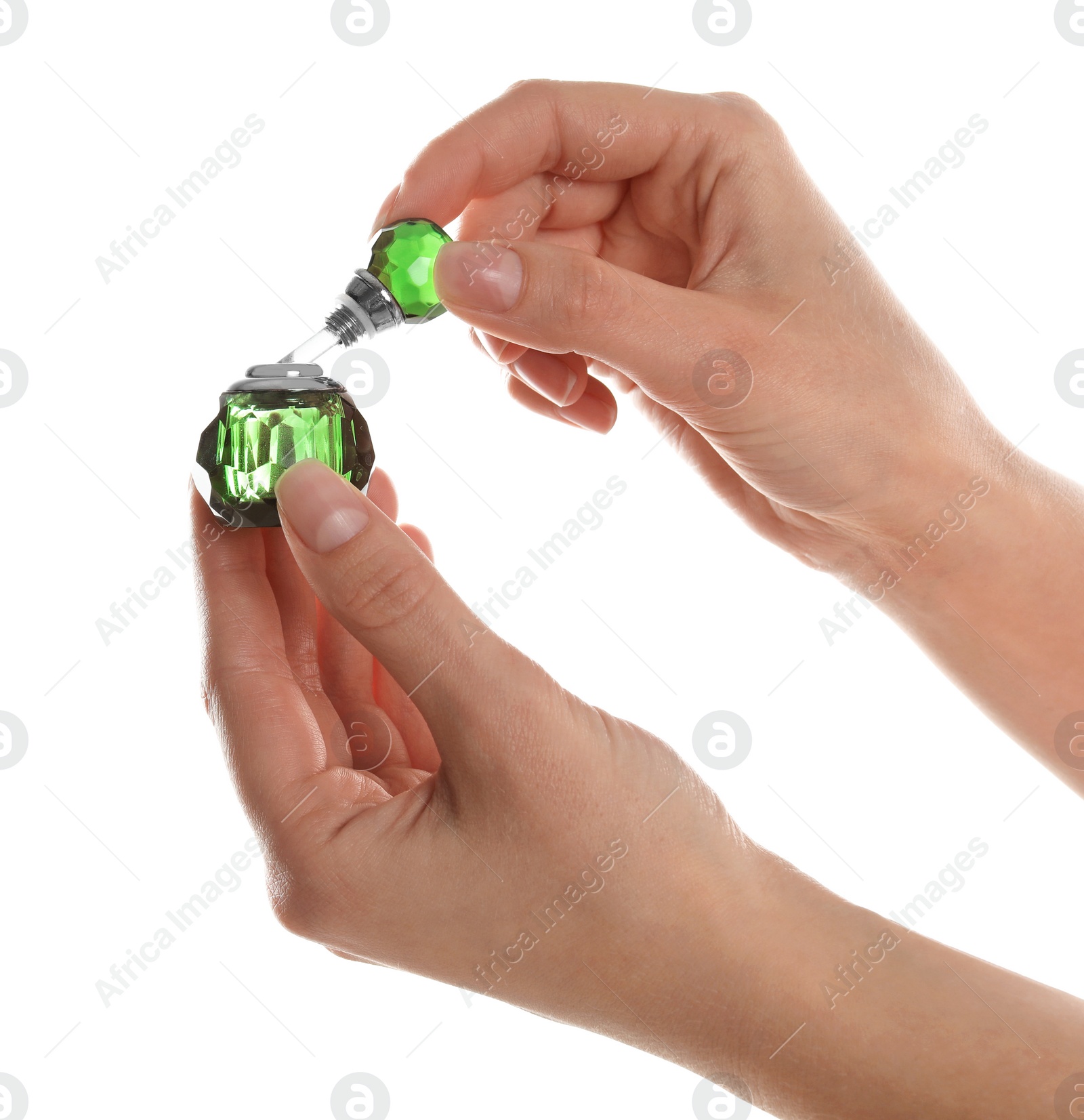 Photo of Woman holding bottle of luxury perfume on white background, closeup