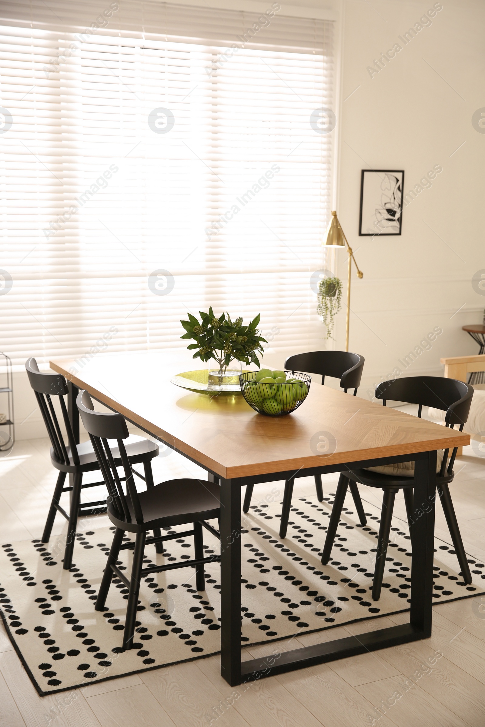 Photo of Stylish wooden dining table and chairs in room. Interior design