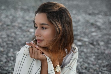 Photo of Portrait of beautiful young woman on pebble beach