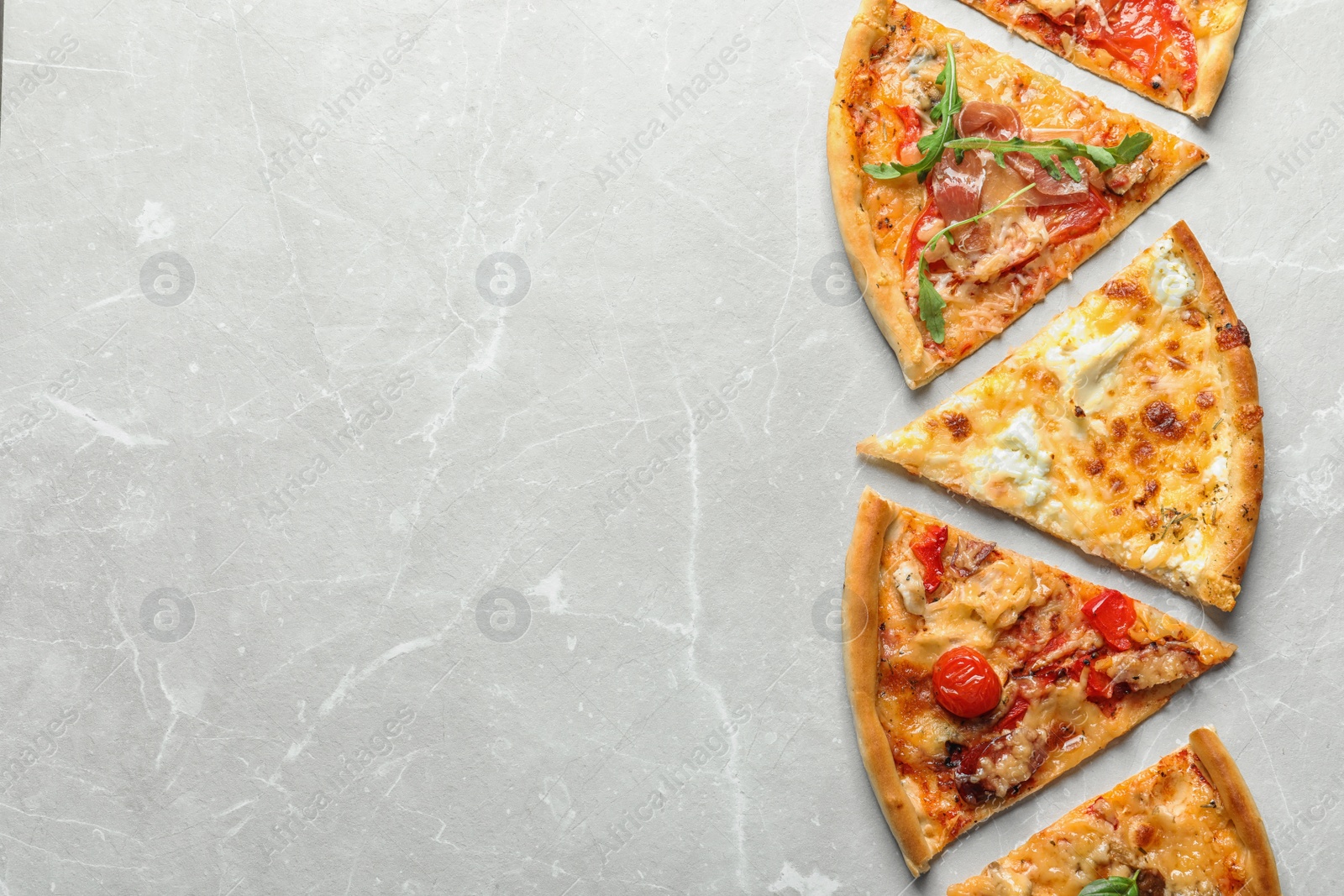 Photo of Slices of delicious pizza on light background, top view