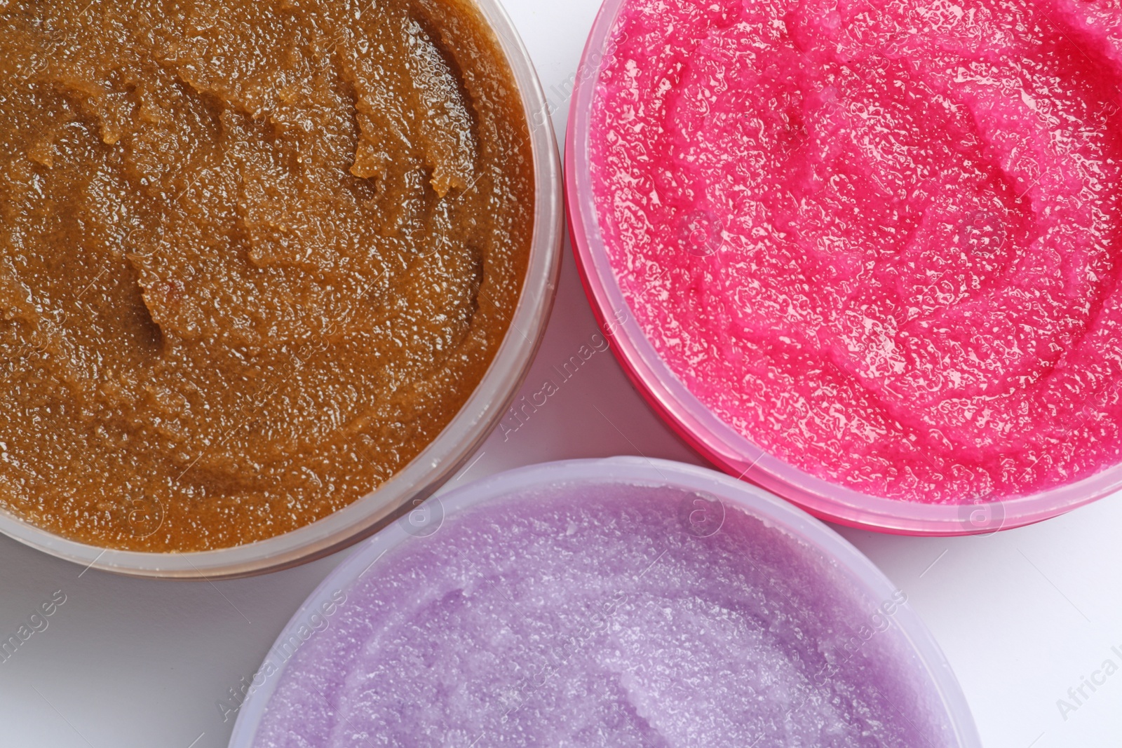 Photo of Containers with natural scrub on white background, top view